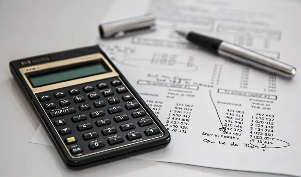 Insurance paperwork and calculator on a desk after a Mesa hit-and-run