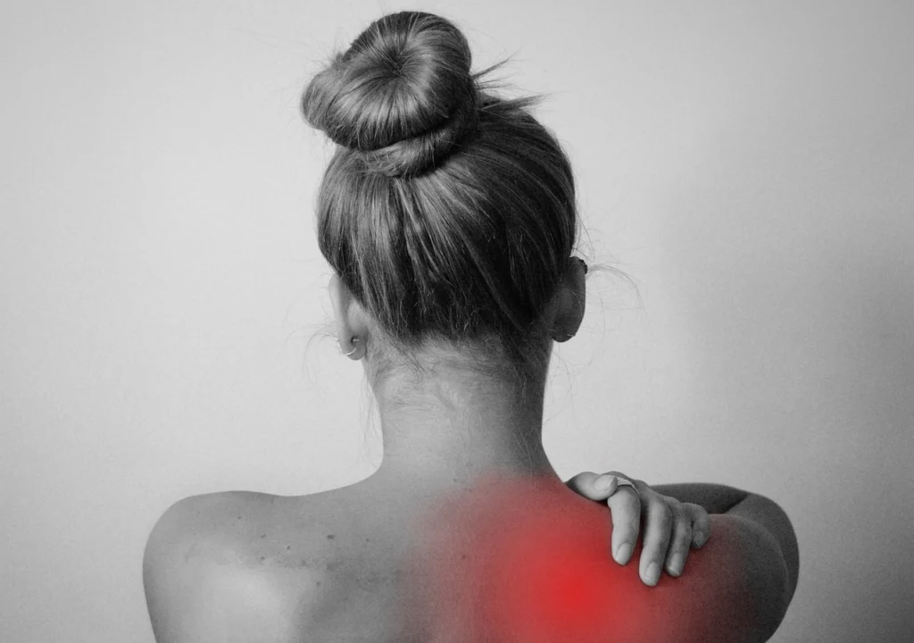Person holding their neck in pain after an accident