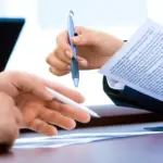 Worker with a bandage reviewing workers' comp documents